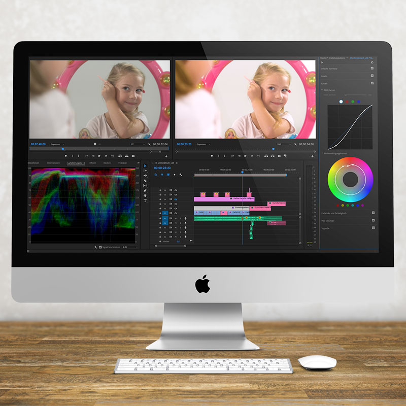 Ein iMac steht auf einem Schreibtisch. Im Videoschnittprogramm Premiere Pro von Adobe werden gerade die Farben bearbietet - zu sehen ist ein kleines Mädchen vorm Barbie Spiegel